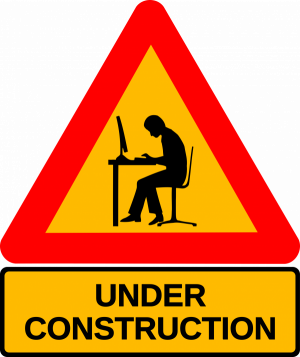 funny - man sitting a laptop in archetypal traffic warning sign